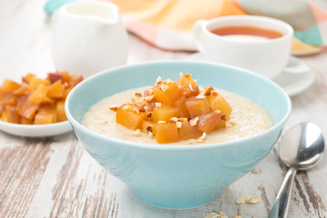 oatmeal with caramelized peaches, tea and yogurt, close-up