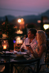 Beautiful couple eating at restaurant outside