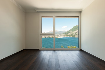 Naklejka na ściany i meble Interior, empty room with window and view on the lake and Lugano