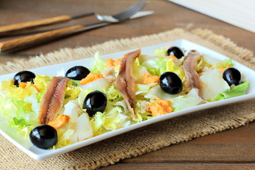Cod, anchovies, and black olives salad
