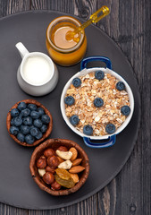 Obraz na płótnie Canvas Oat flakes, blueberries, nuts, honey and milk.