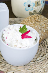 cottage cheese with radish, milk jug and wholemeal bun