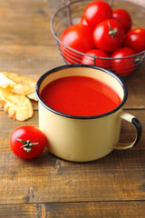 Homemade tomato juice in color mug, toasts and fresh tomatoes