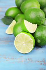 Fresh juicy limes on old wooden table