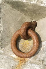 Iron ring set in concrete.