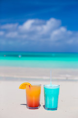 Close up tasty cocktails on the white sandy beach