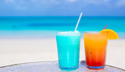 Close up Blue Curacao and Mango cocktail on the white sandy