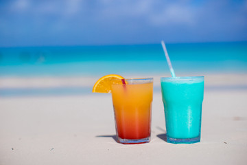 Close up Blue Curacao and Mango cocktail on the white sandy