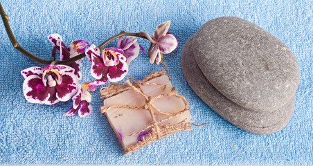Fototapeta na wymiar Spa stones, soap and pink orchid