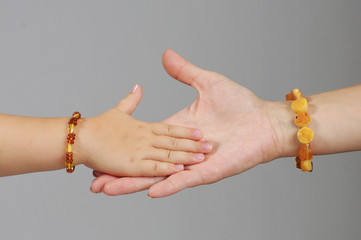 Daughter hand playing with mother hand