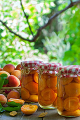 Apricot compote in the jars, vertical
