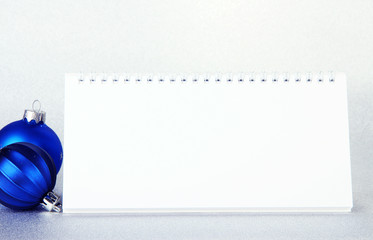 Empty calendar and New Year decor on light background