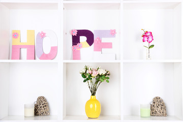 White shelves decorated with handmade knit word