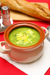 Tasty soup in saucepan on tablecloth, close up