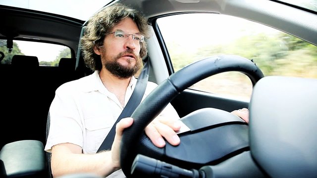 Furious angry man driving car shouting