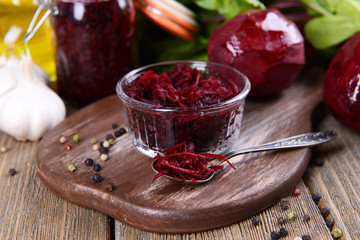 Grated beetroots in bowl on table close-up