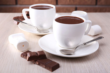 Cups of hot chocolate on table, close up