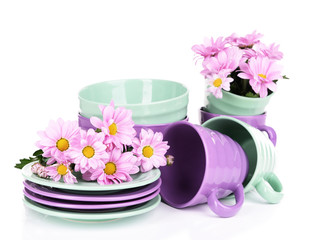 Obraz na płótnie Canvas Bright dishes with flowers isolated on white