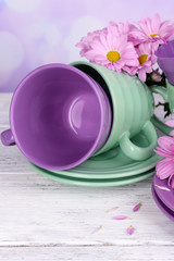 Obraz na płótnie Canvas Bright cups and saucers with flowers