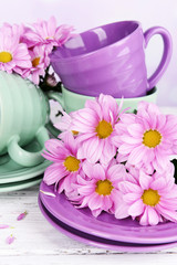 Bright cups and saucers with flowers