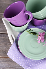 Bright dishes with flowers on table close up