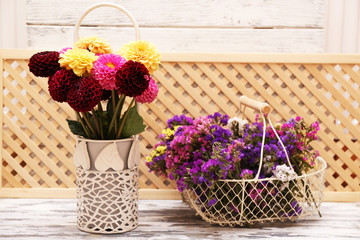 Dahlia flowers in vase on wooden table