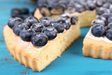 Tasty homemade pie with blueberries on wooden table