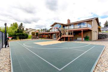 Fototapeta na wymiar House backyard with sport court and patio area