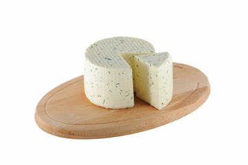 Cheese with dill on wooden cutting board