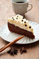 Slice piece of vanilla cake topping with white chocolate chips