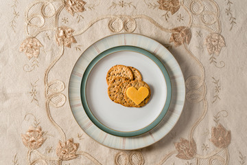 Obraz na płótnie Canvas Heart shaped cheese on cracker