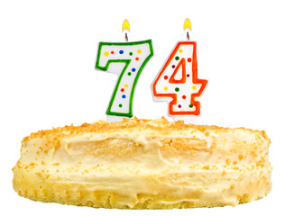 birthday cake with candles number seventy four isolated