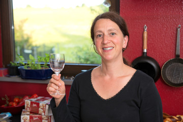 woman drinking wine in the kitchen
