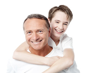 Obraz premium Smiling father holding son on his shoulders