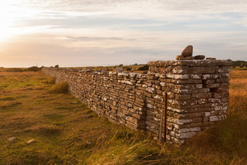 High stone wall in sunset