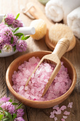 spa with pink herbal salt and clover flowers