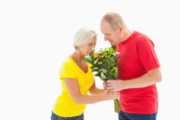 Mature man offering his partner flowers