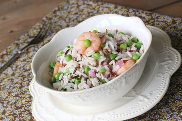 Rice salad with shrimps, red onions and peas