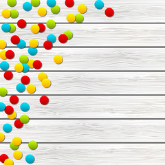 Color confetti on wooden background