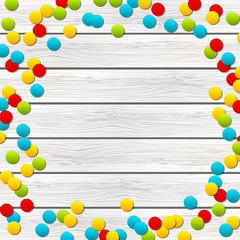 Color confetti on wooden background