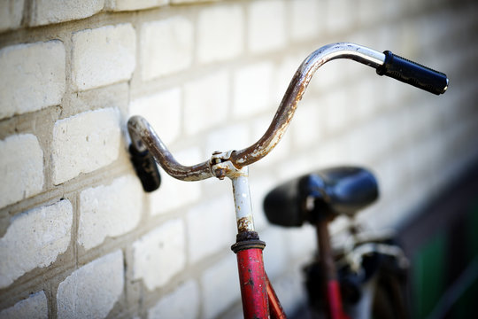 the old bicycle costs at a house wall