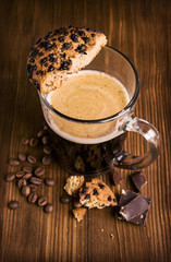 coffee in a glass cup with chocolate biscuits
