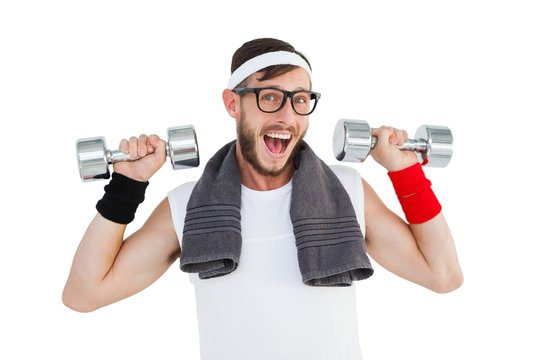 Geeky hipster lifting dumbbells in sportswear