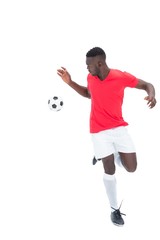 Football player in red jersey controlling ball