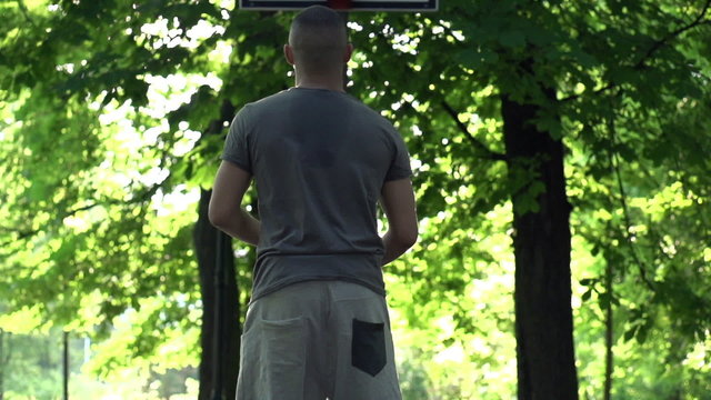 Man missed basketball throw on court in park, super slow motion