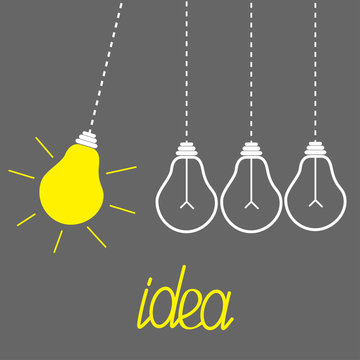 Hanging yellow light bulbs. Perpetual motion. Idea concept. Grey
