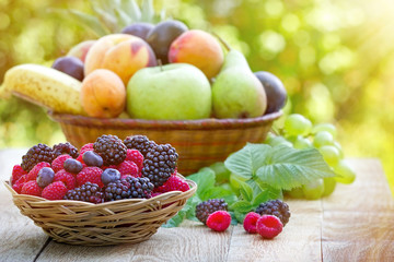 Naklejka na ściany i meble Fresh organic fruits in wicker basket