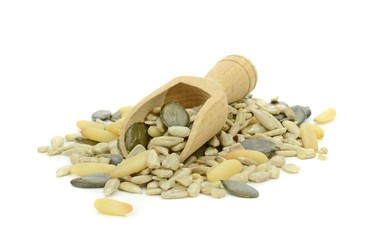 Mixed pine nuts, sunflower and pumpkin seeds with wooden scoop