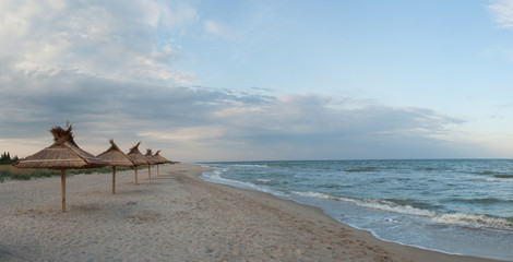 Straw umbrellas on beach