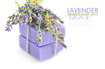 Handmade soap and lavender flowers on a white background